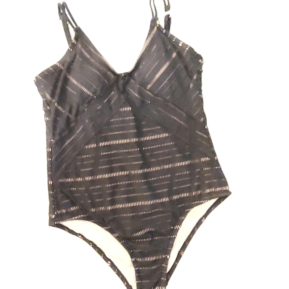 One Piece Black Bathing Suit with Tan Lining.